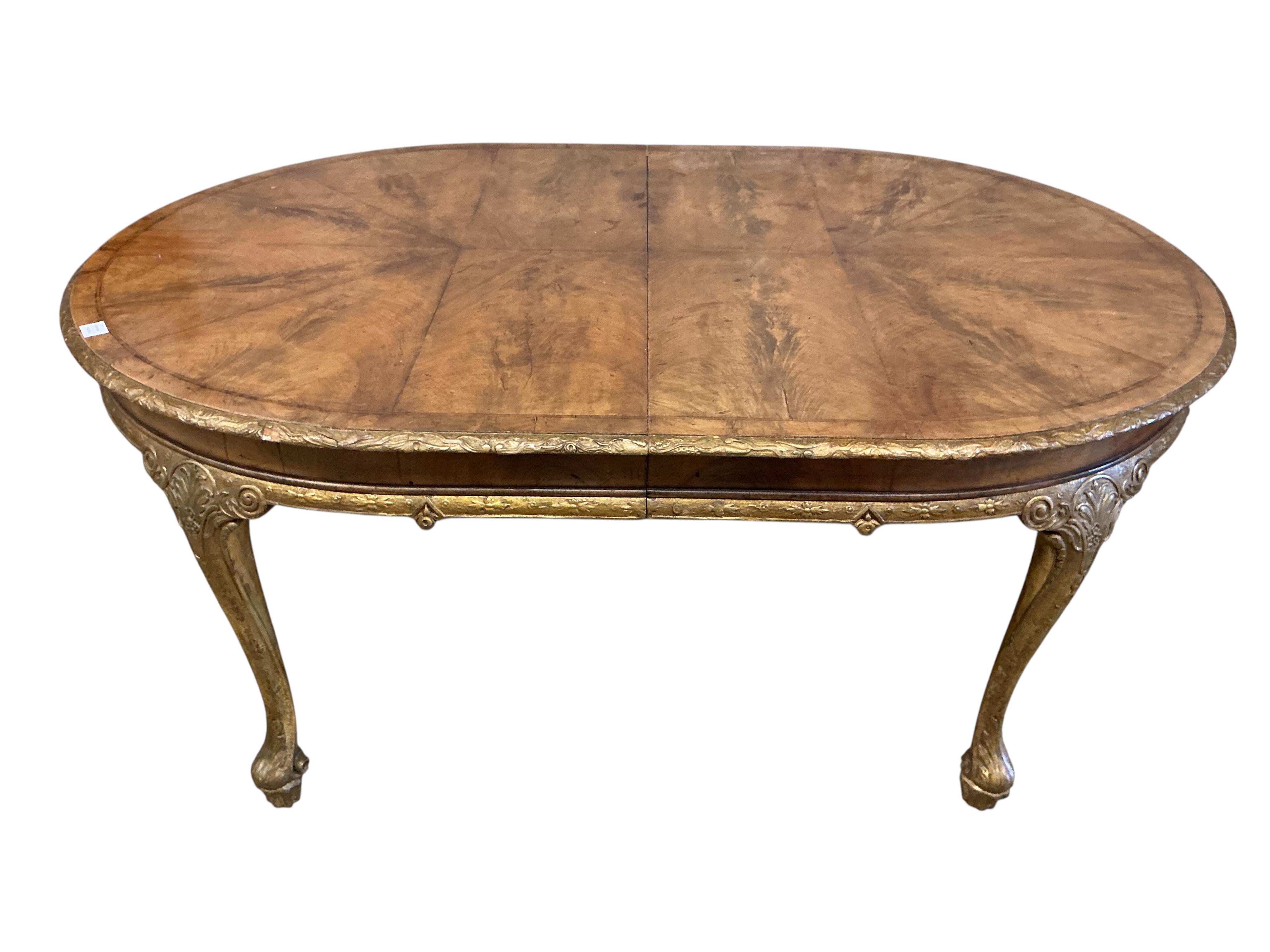 A George I style banded parcelgilt walnut extending dining table, width 300cm extended, one spare leaf, depth 120cm, height 76cm